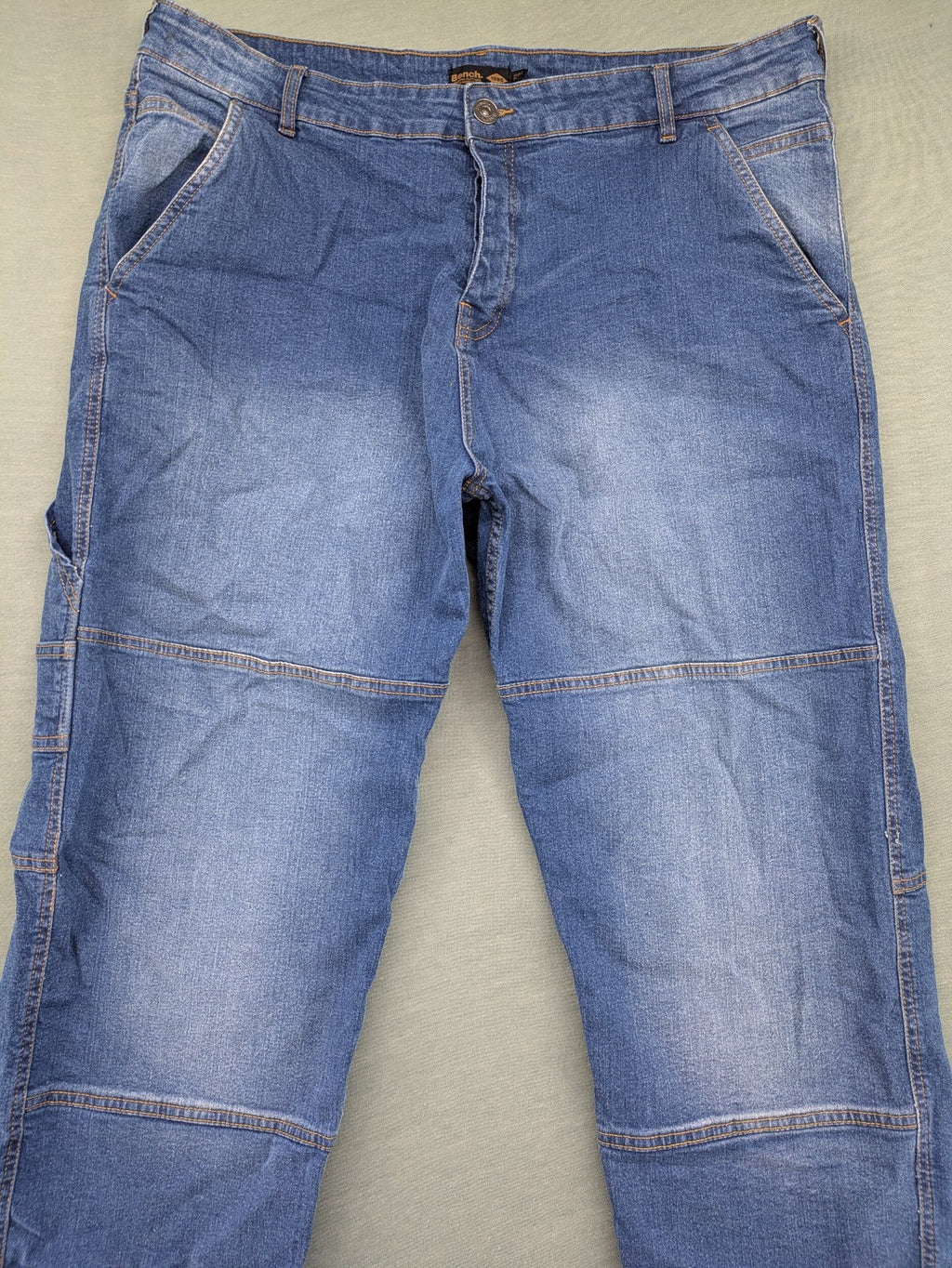 Bench blue straight jeans with reinforced knees and multiple cargo pockets.