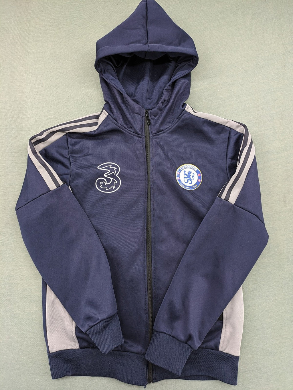 Chelsea FC grey and navy tracksuit set with full zip hoodie and three logos.