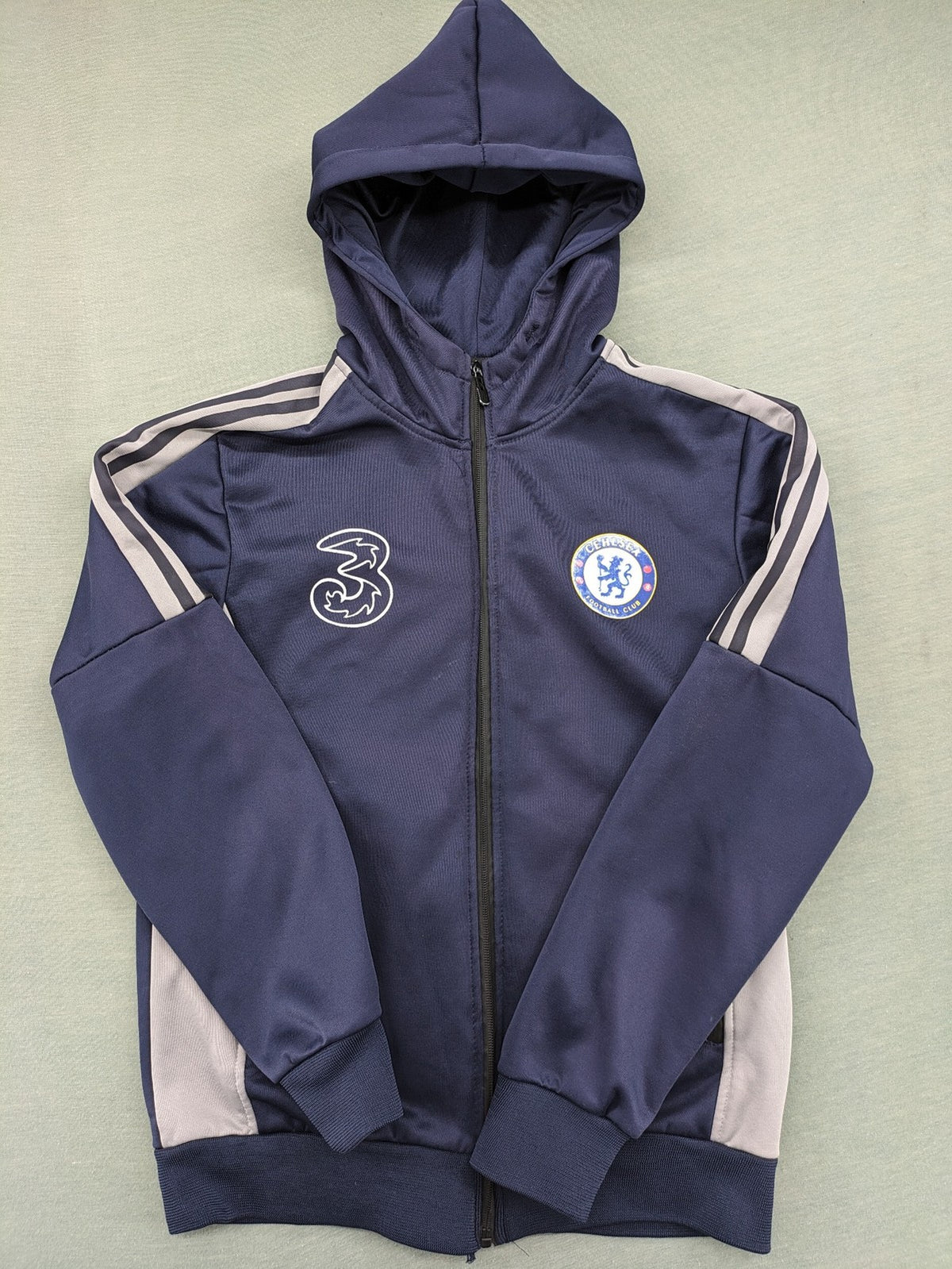 Chelsea FC grey and navy tracksuit set with full zip hoodie and three logos.