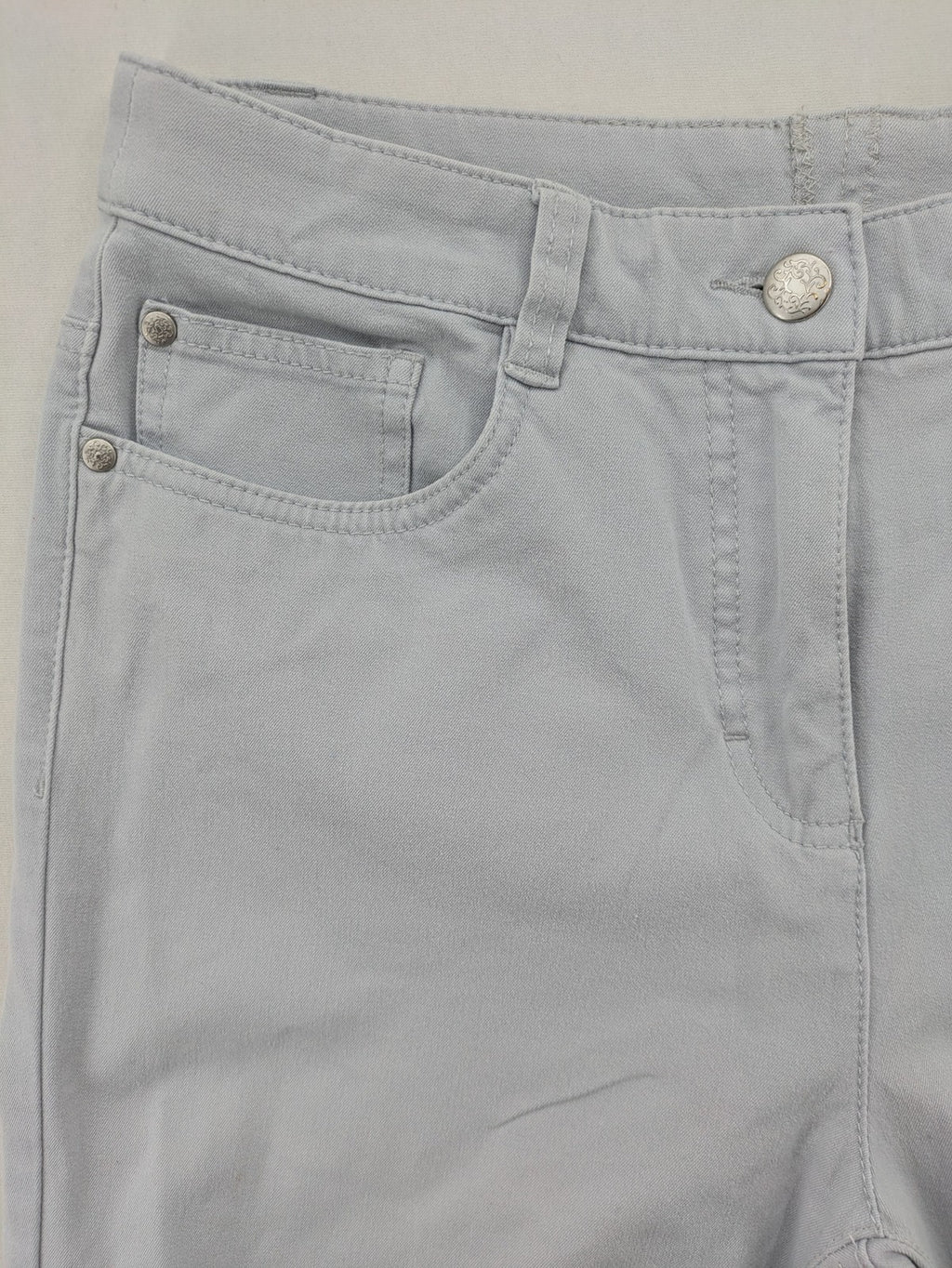 Chino grey capri pants five-pocket design with subtle embroidery and stretch cotton blend.