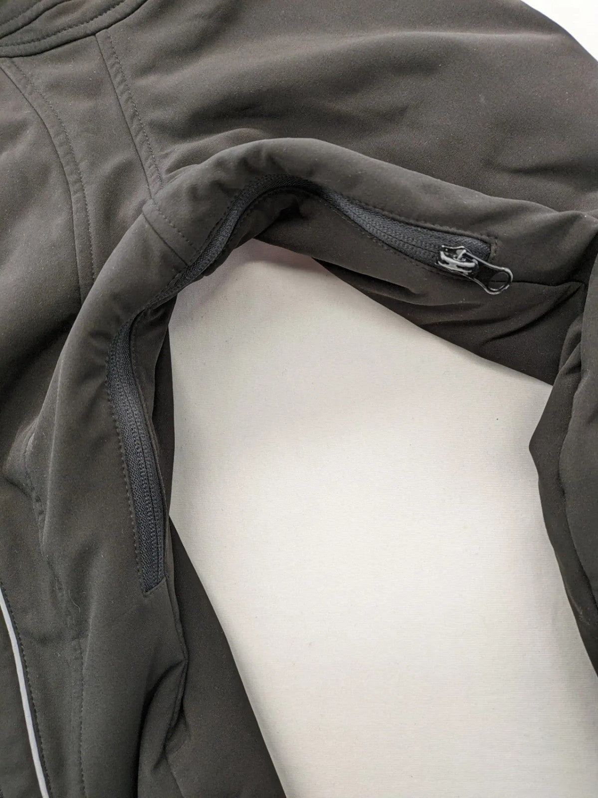 James & Nicholson grey softshell jacket with fleece lining and multiple zip pockets.