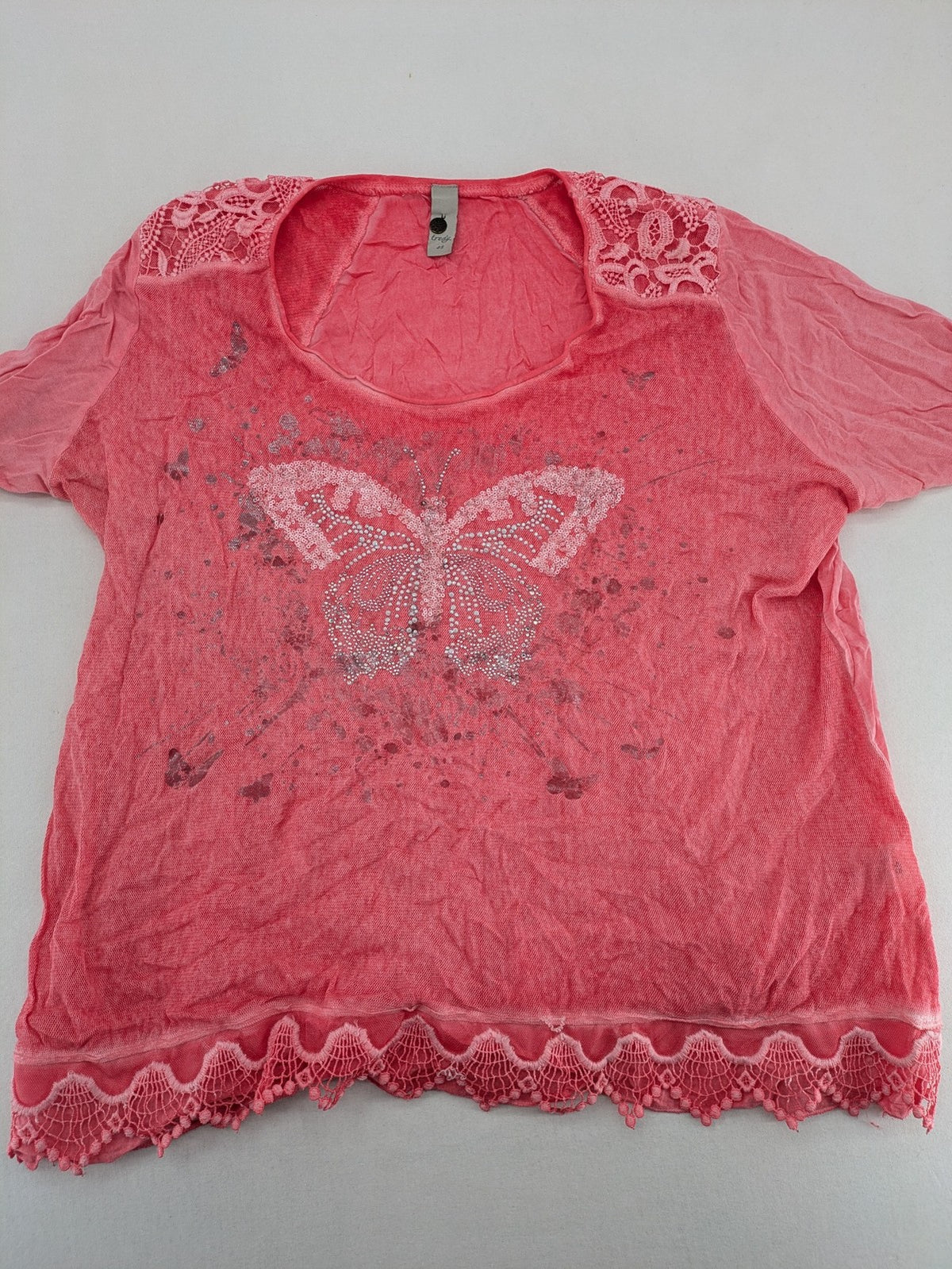 TREDY pink top with butterfly graphic, embellished with rhinestones and lace accents.