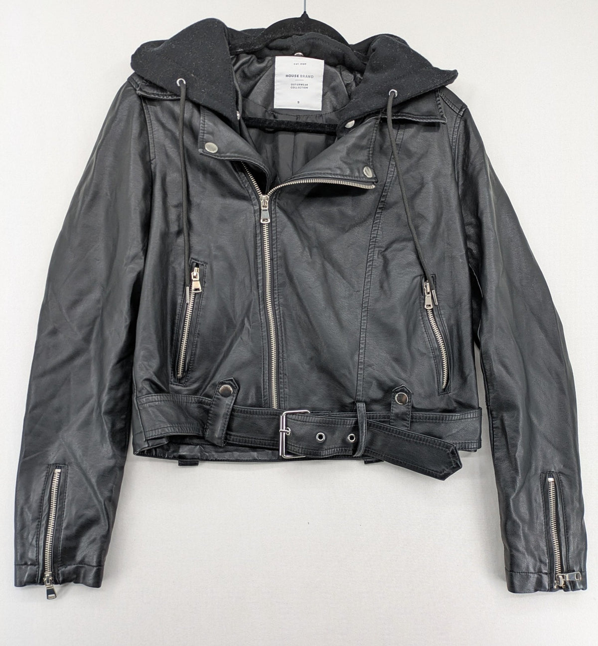 House Brand black biker jacket with hood, asymmetrical zipper, and belt detail.