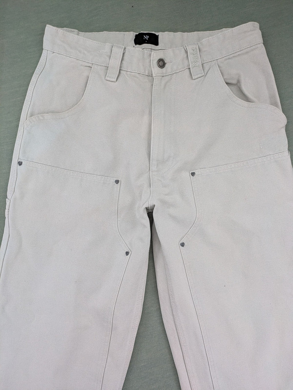 NUDE beige pants with double knee reinforcements and multiple utility pockets.