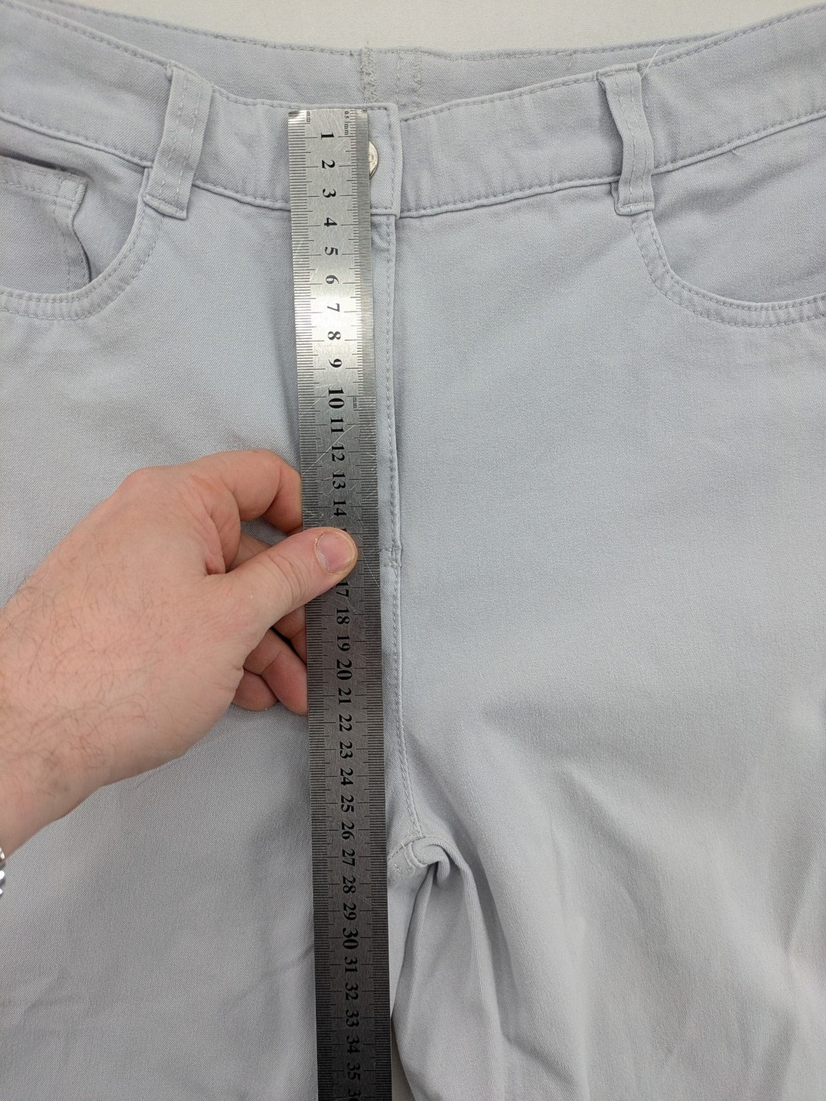 Chino grey capri pants five-pocket design with subtle embroidery and stretch cotton blend.