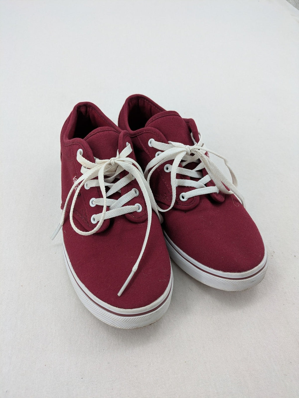 Vans low-top sneakers burgundy canvas with white logo and classic waffle sole.