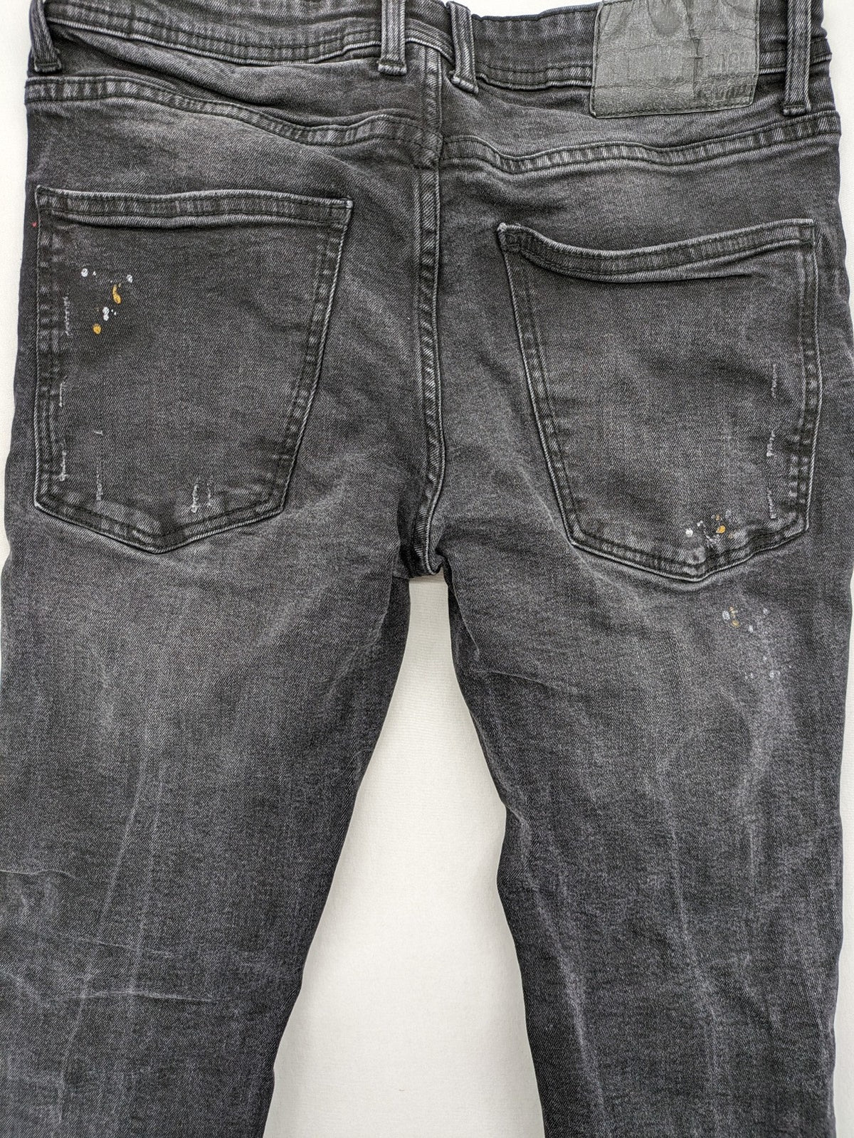 Black Squad skinny fit jeans black distressed ripped design with subtle paint splatter.