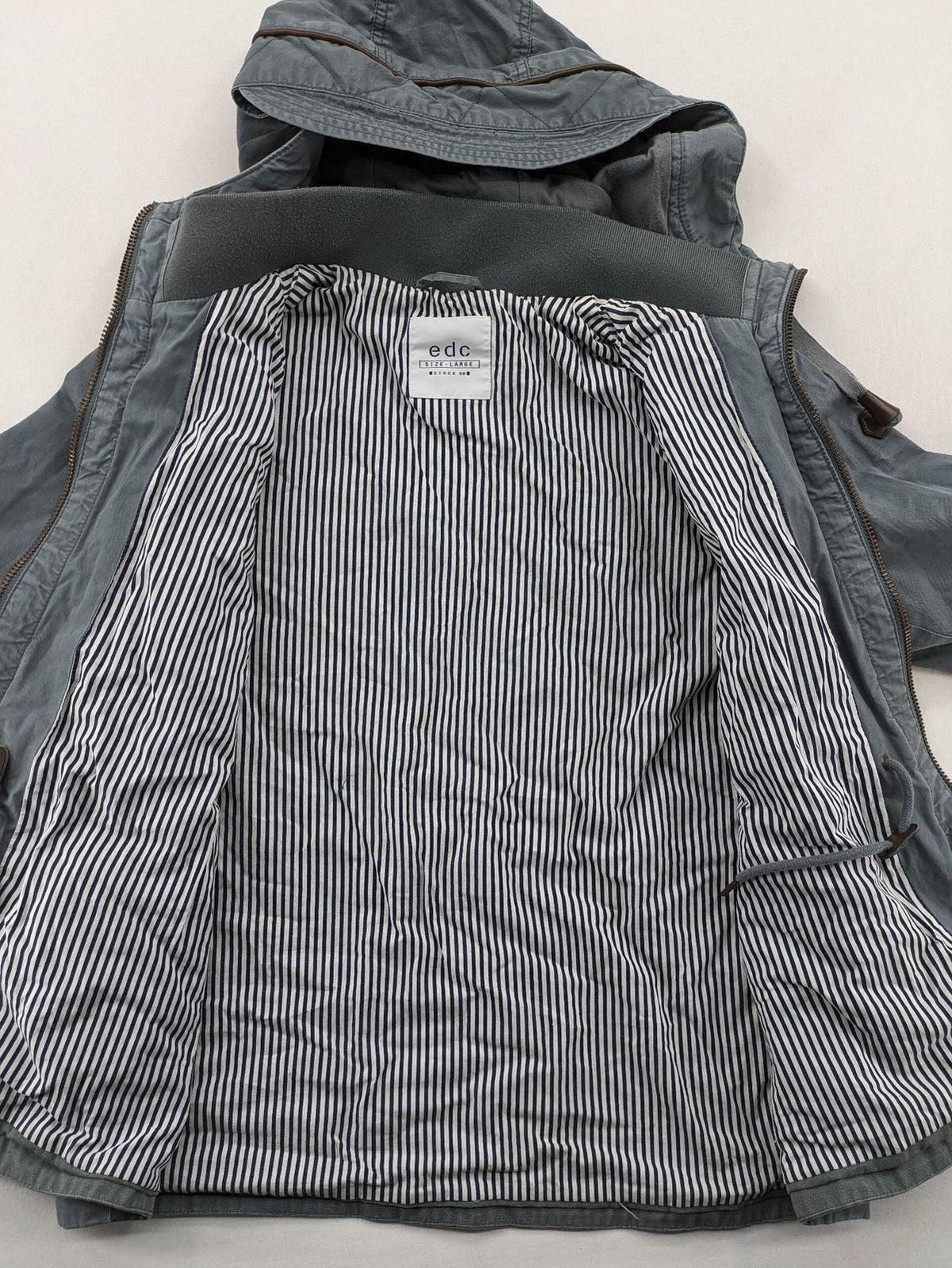 edc grey parka jacket with hood, adjustable drawstrings, and striped lining