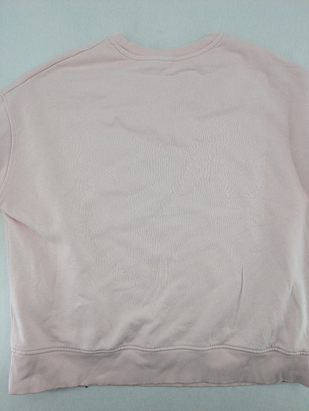 Hello Kitty pink sweatshirt classic graphic face logo on chest, long sleeves, round neck.