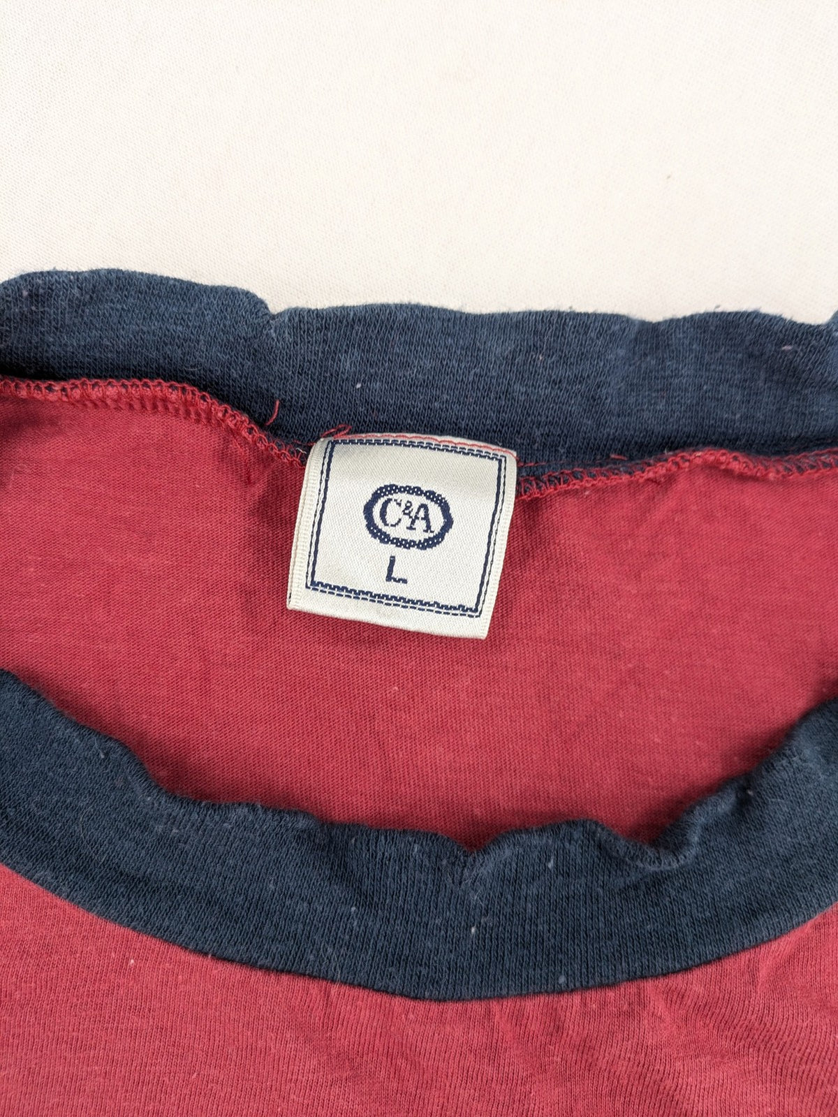 C&A green navy red colorblock long sleeve top with wide striped pattern and round neckline.