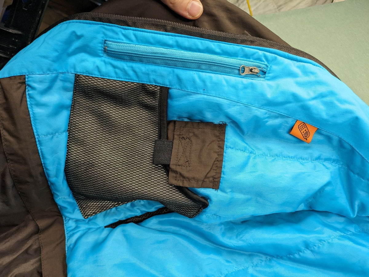 Thinsulate black and blue ski jumpsuit with hood and zippered pockets.