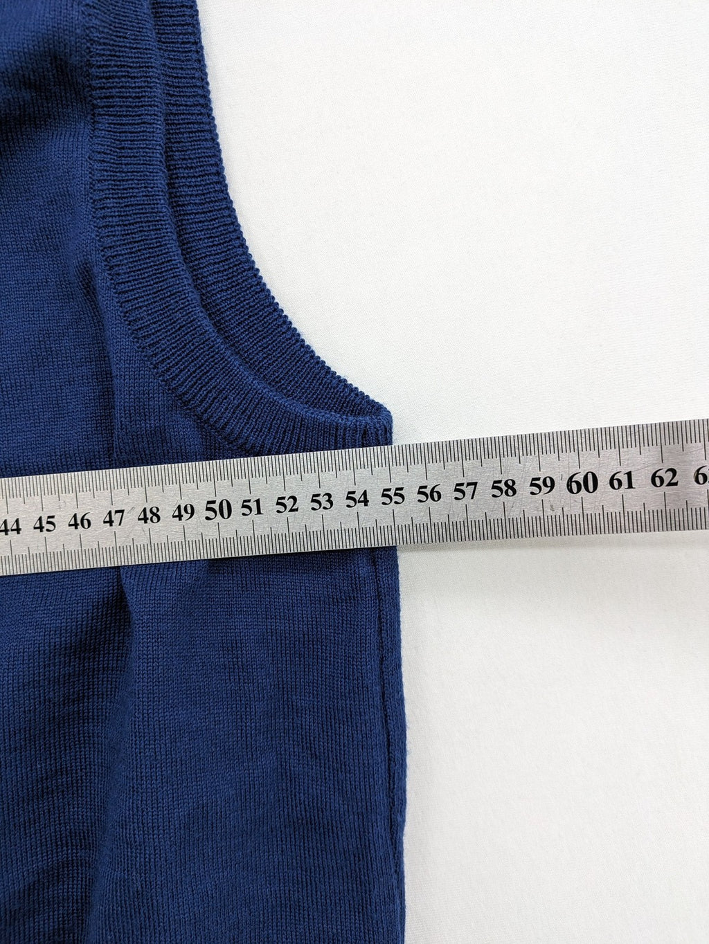 Montechiaro blue turtle neck jumper with V-neck, button placket, and sleeveless design.