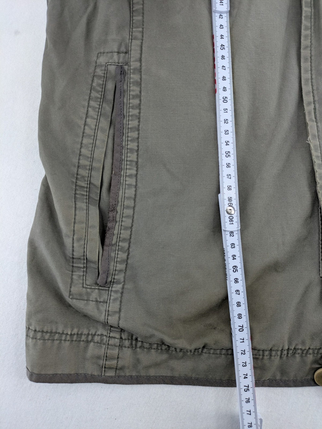 Walbusch khaki military jacket with checkered blue-white lining and multiple pockets.