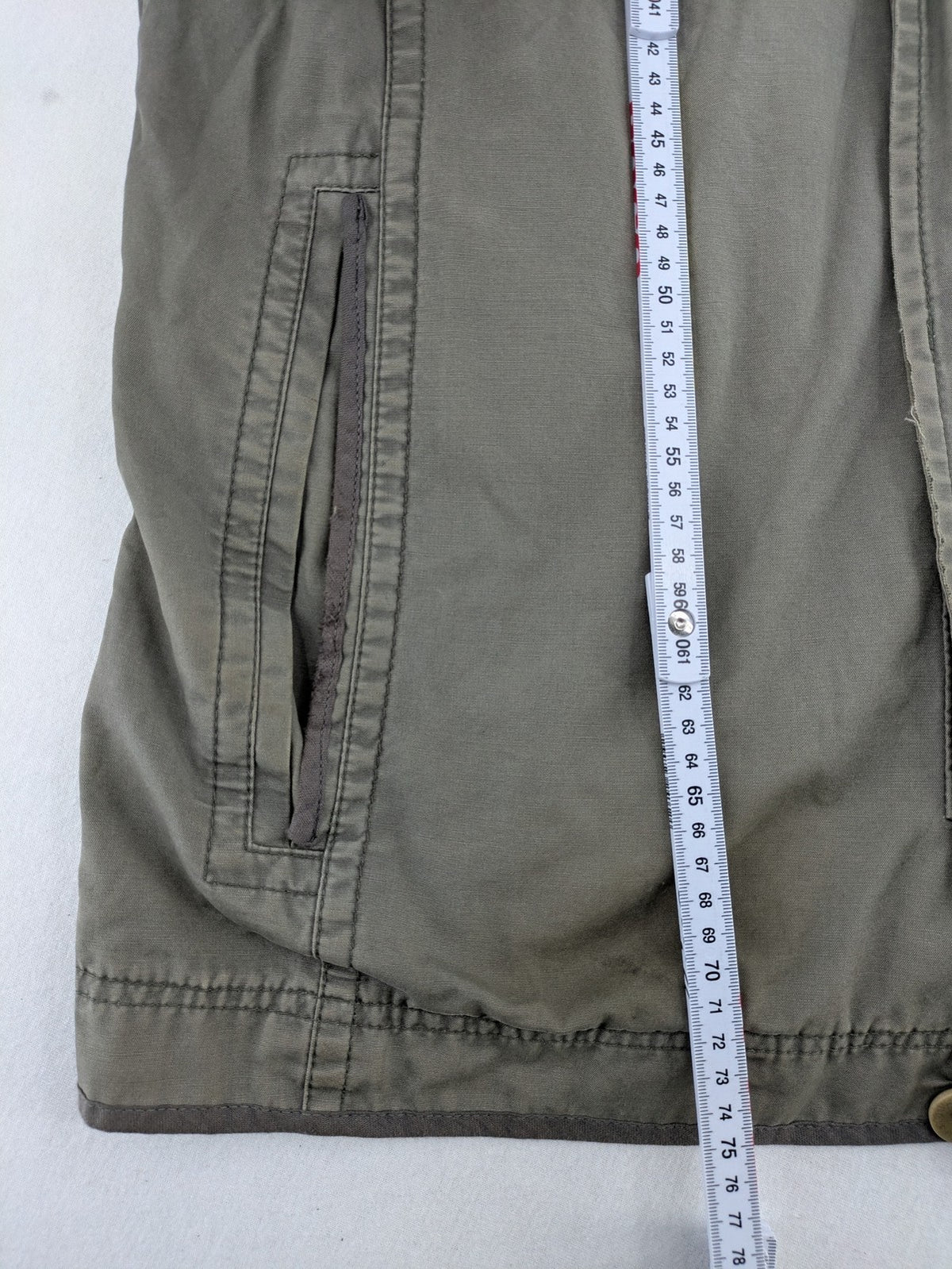 Walbusch khaki military jacket with checkered blue-white lining and multiple pockets.