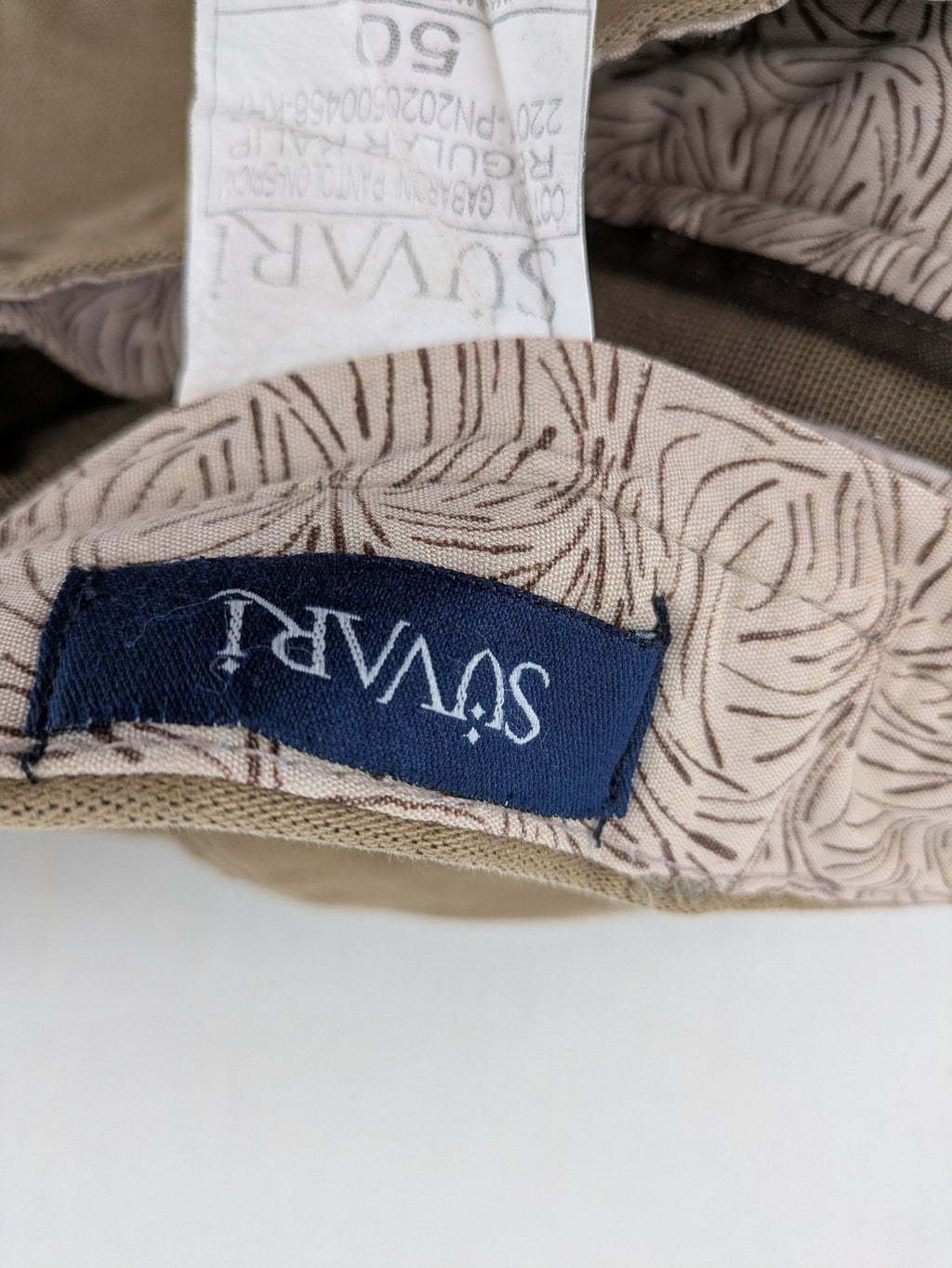 Süvari khaki chino pants flat-front design with patterned waistband detail, cotton blend material.