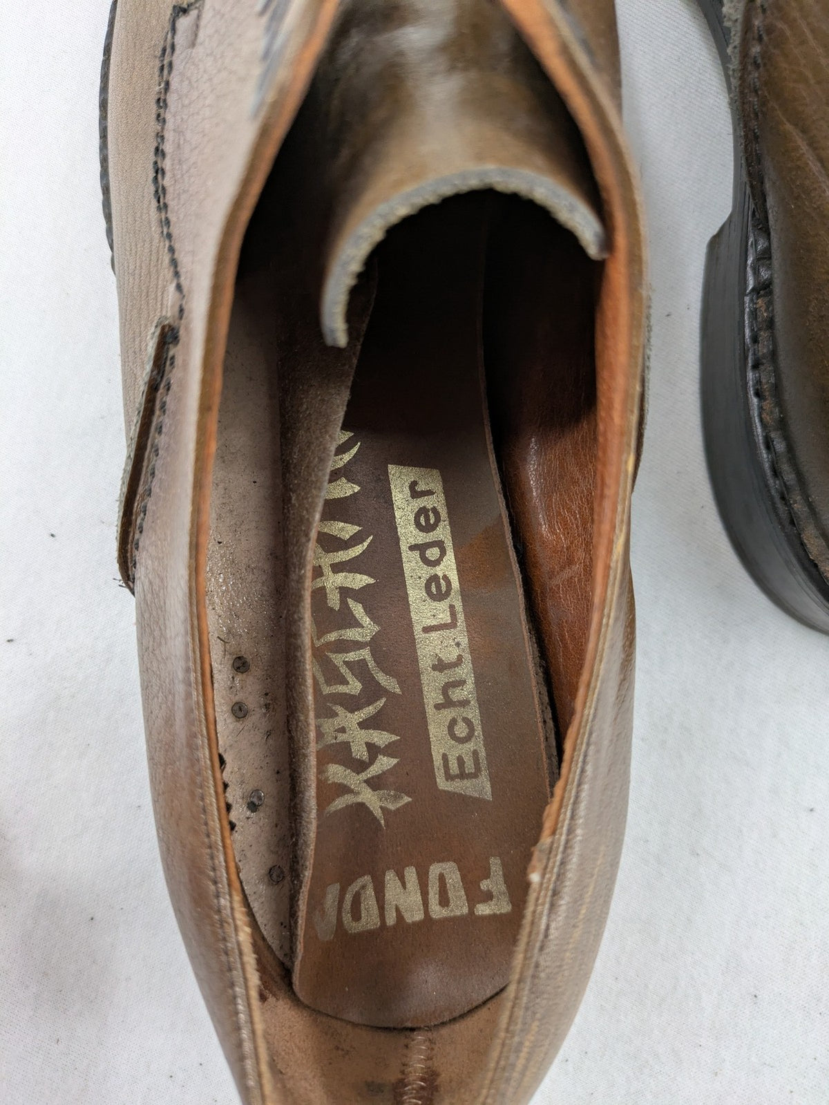 Fonda brown deck shoes genuine leather square toe design with decorative stitching.