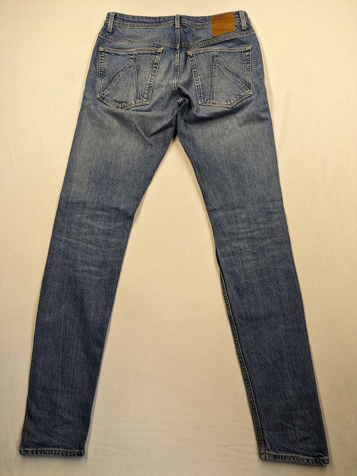 CHASIN' blue slim fit jeans with button fly and classic denim craftsmanship.