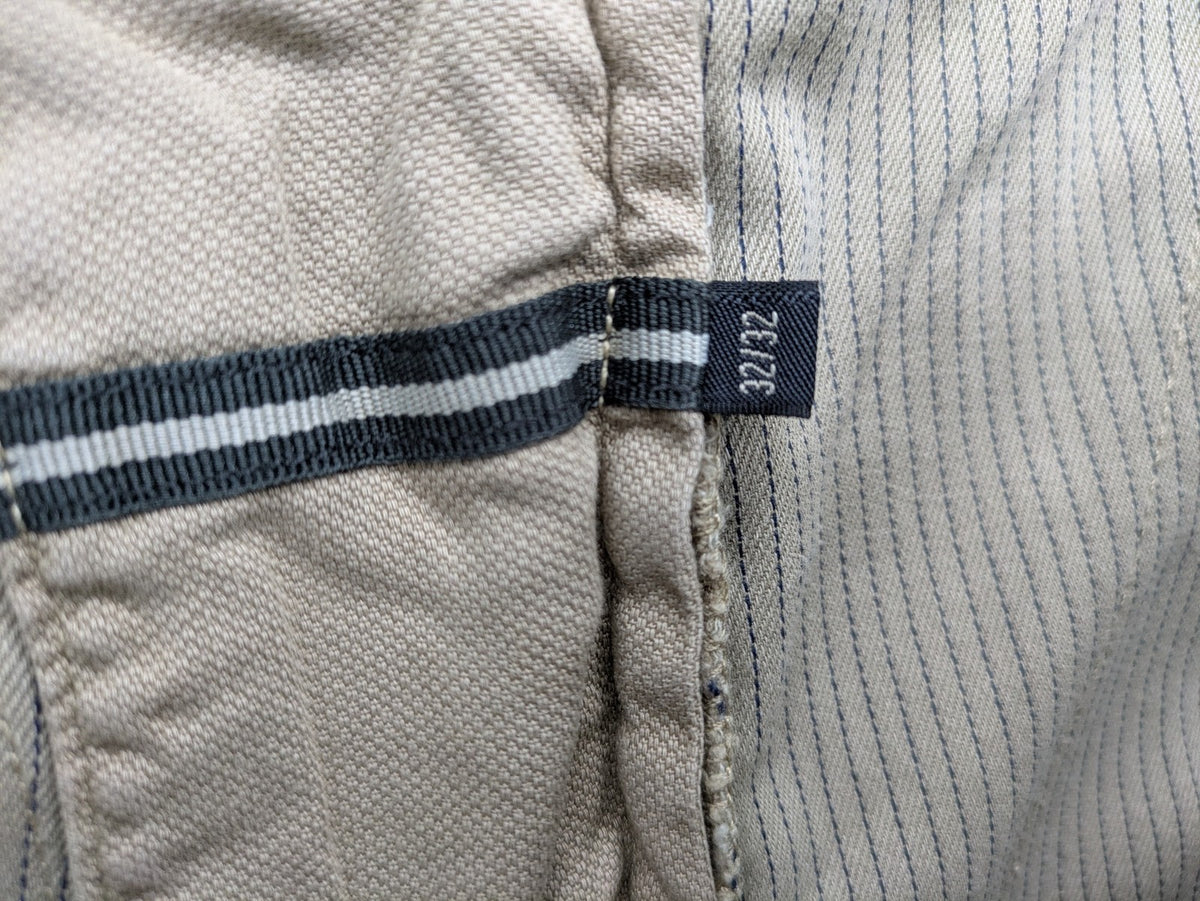 Marc O'Polo beige tapered fit chino pants, soft cotton stretch fabric, modern silhouette.