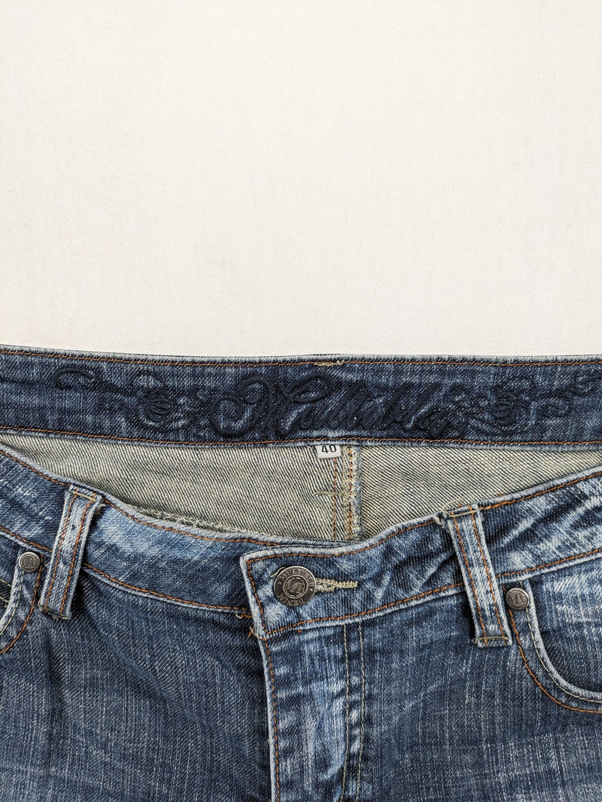 BLU blue straight jeans with washed effect, rolled hem, and five-pocket design.