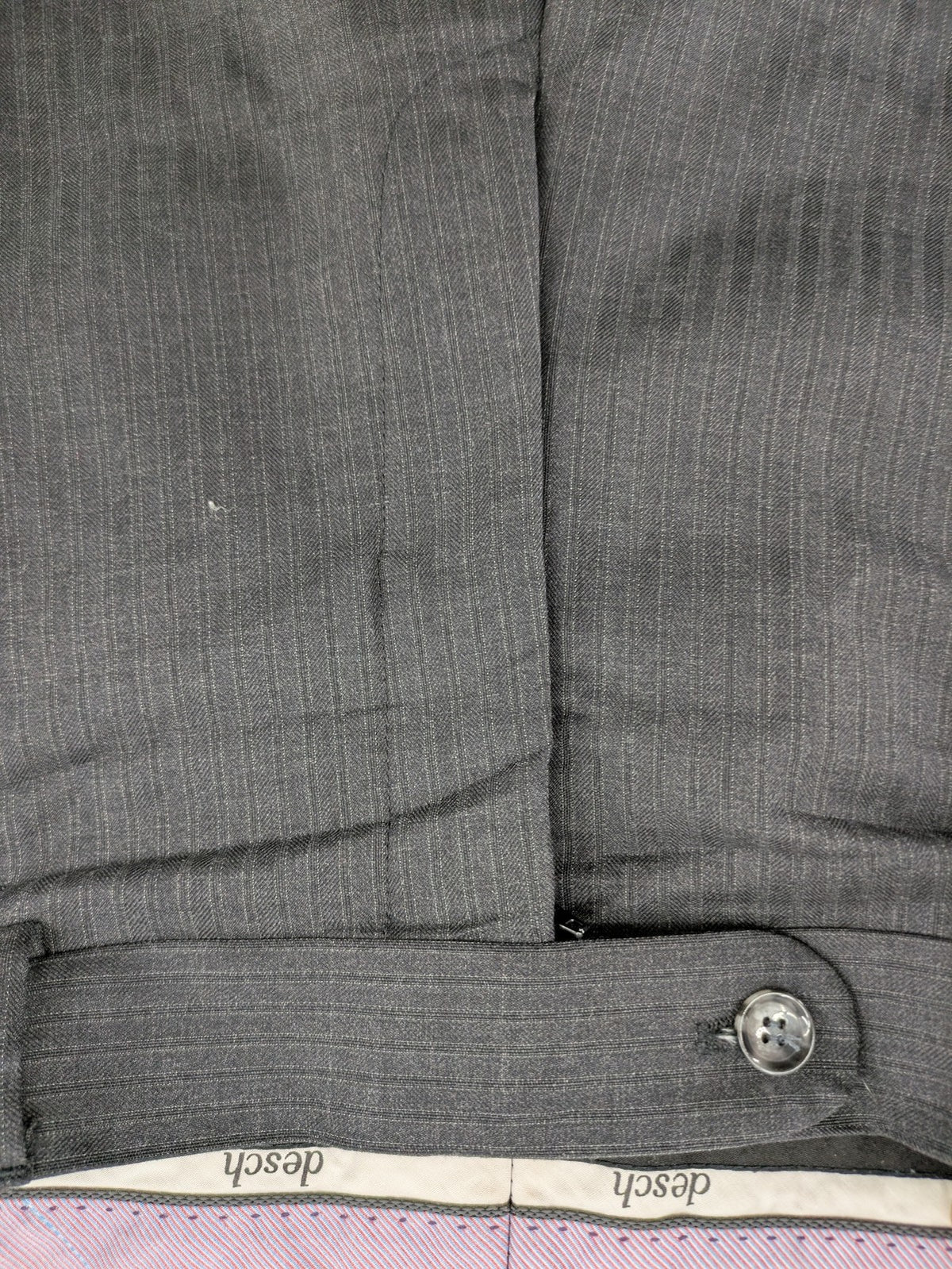 Desch grey suit pants with subtle pinstripe pattern and flat front design.