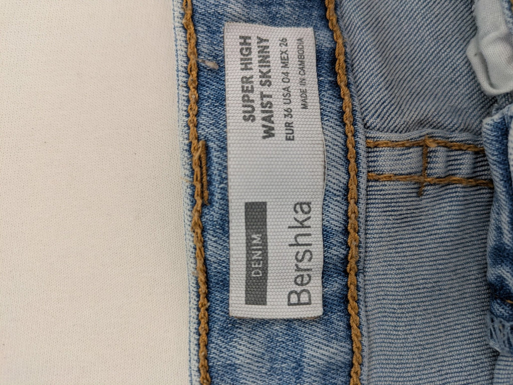 Bershka blue super high waist skinny jeans with washed denim finish and zip closure.