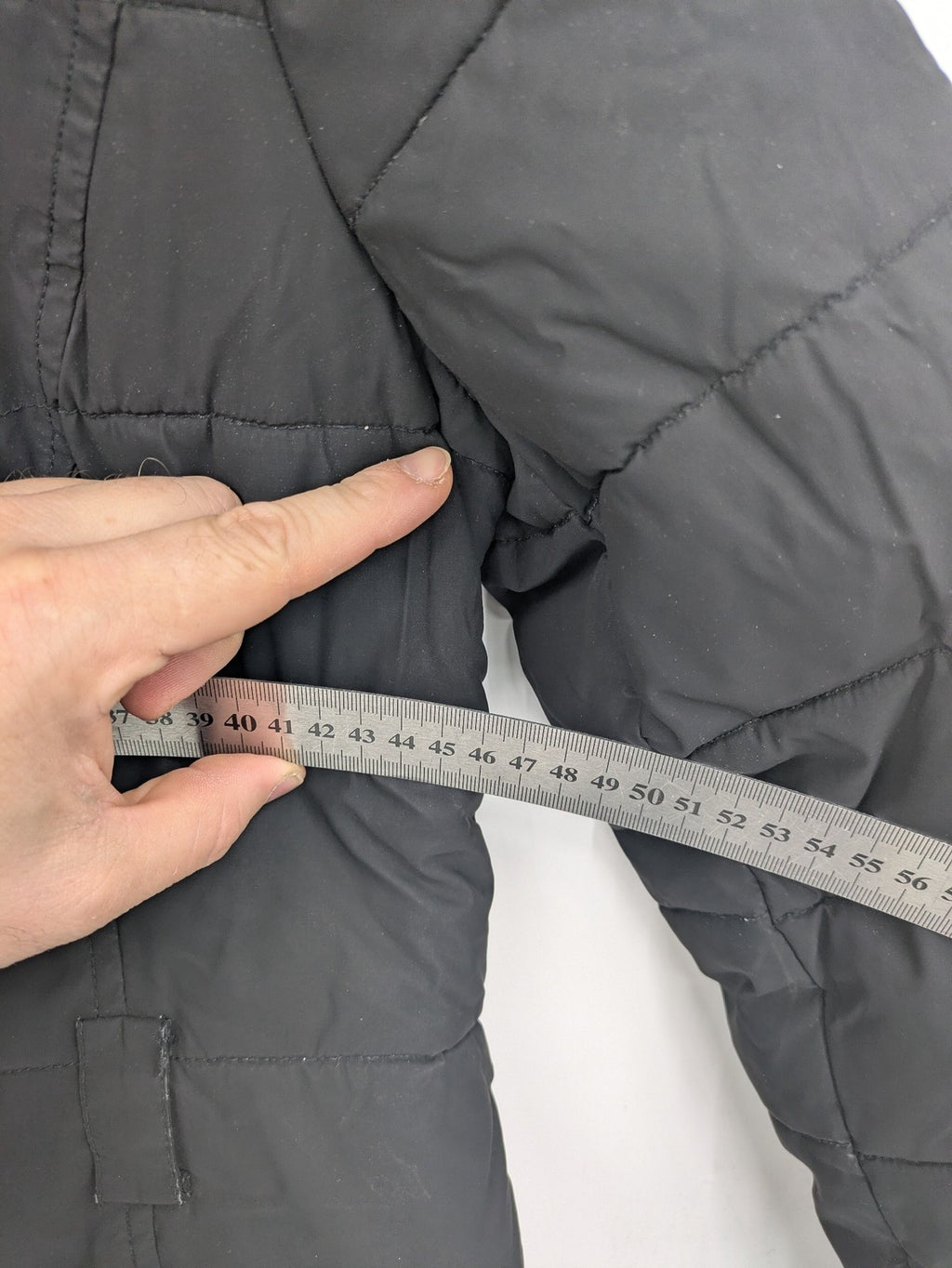 Mark Adam grey quilted jacket with high collar and buttoned flap pockets.