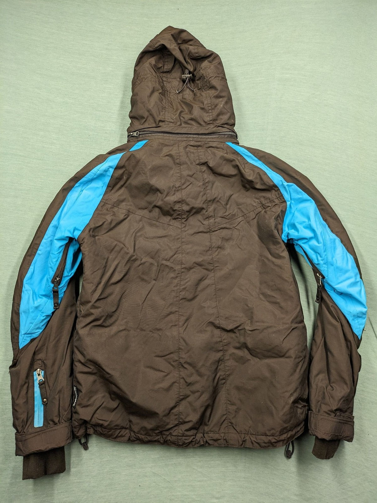 Thinsulate black and blue ski jumpsuit with hood and zippered pockets.