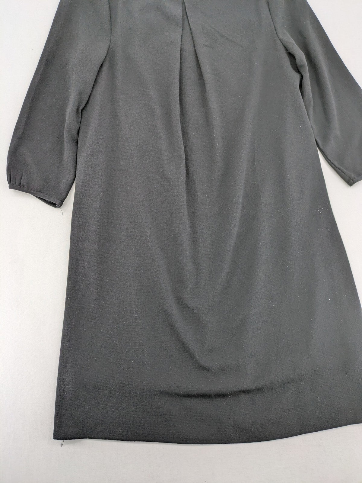 Infinity grey bridal party dress with pleated front and 3/4 sleeves.