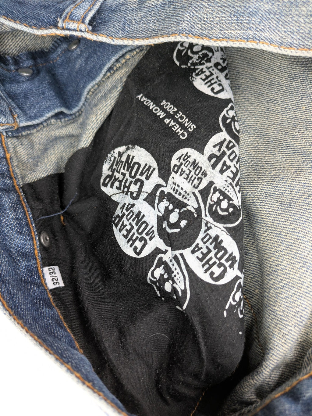 Cheap Monday blue straight jeans with button fly and classic medium wash finish.
