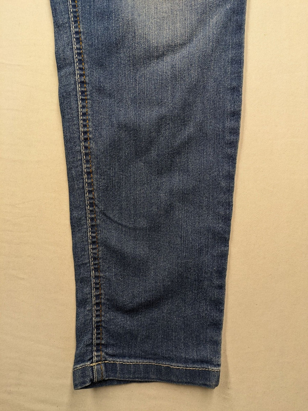 Rainbow blue straight jeans with elastic waistband and decorative knee stitching.