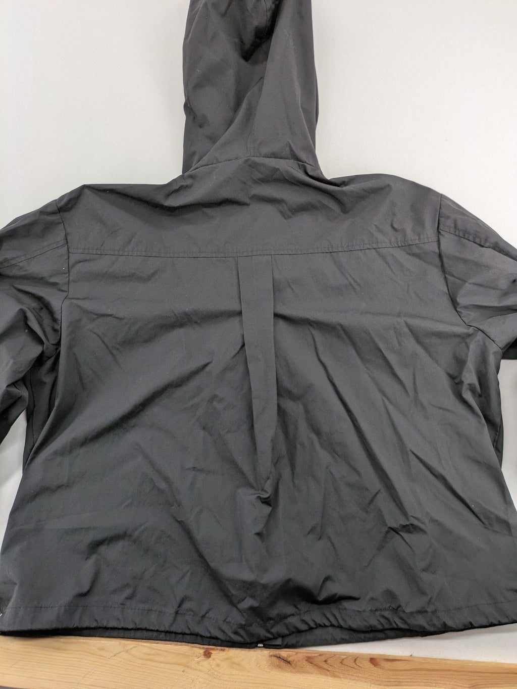 Hypnotism grey windbreaker jacket with hood, snap buttons, and zip closure.