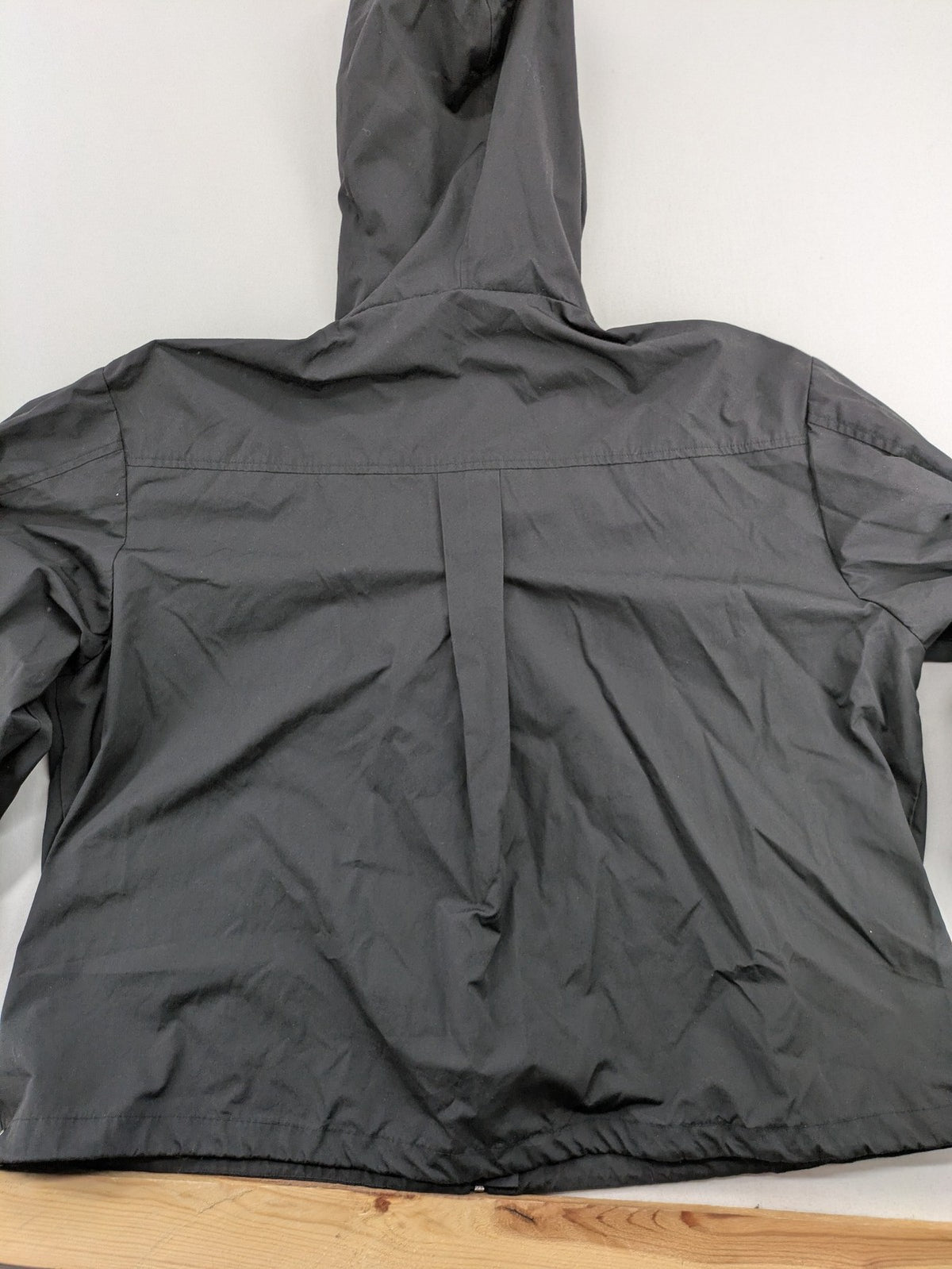 Hypnotism grey windbreaker jacket with hood, snap buttons, and zip closure.