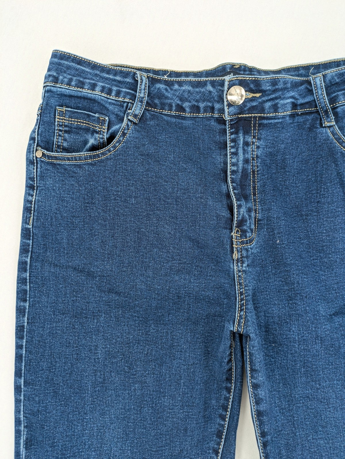 Miss Good blue straight jeans with 5-pocket design and decorative metal accent.