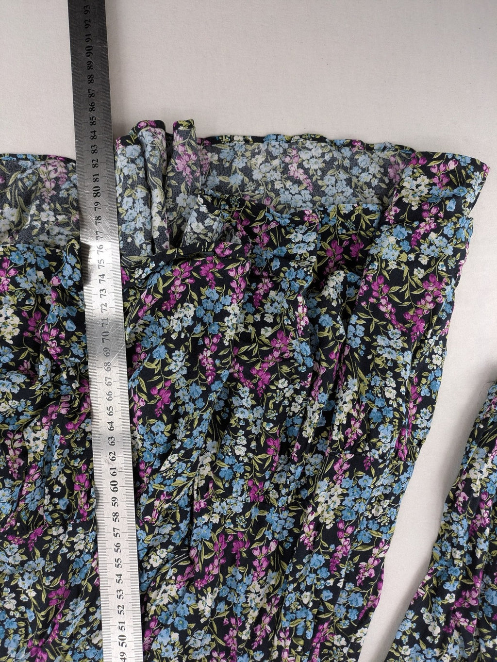 Zara multi-coloured floral mini dress with classic collar and button placket on black background.