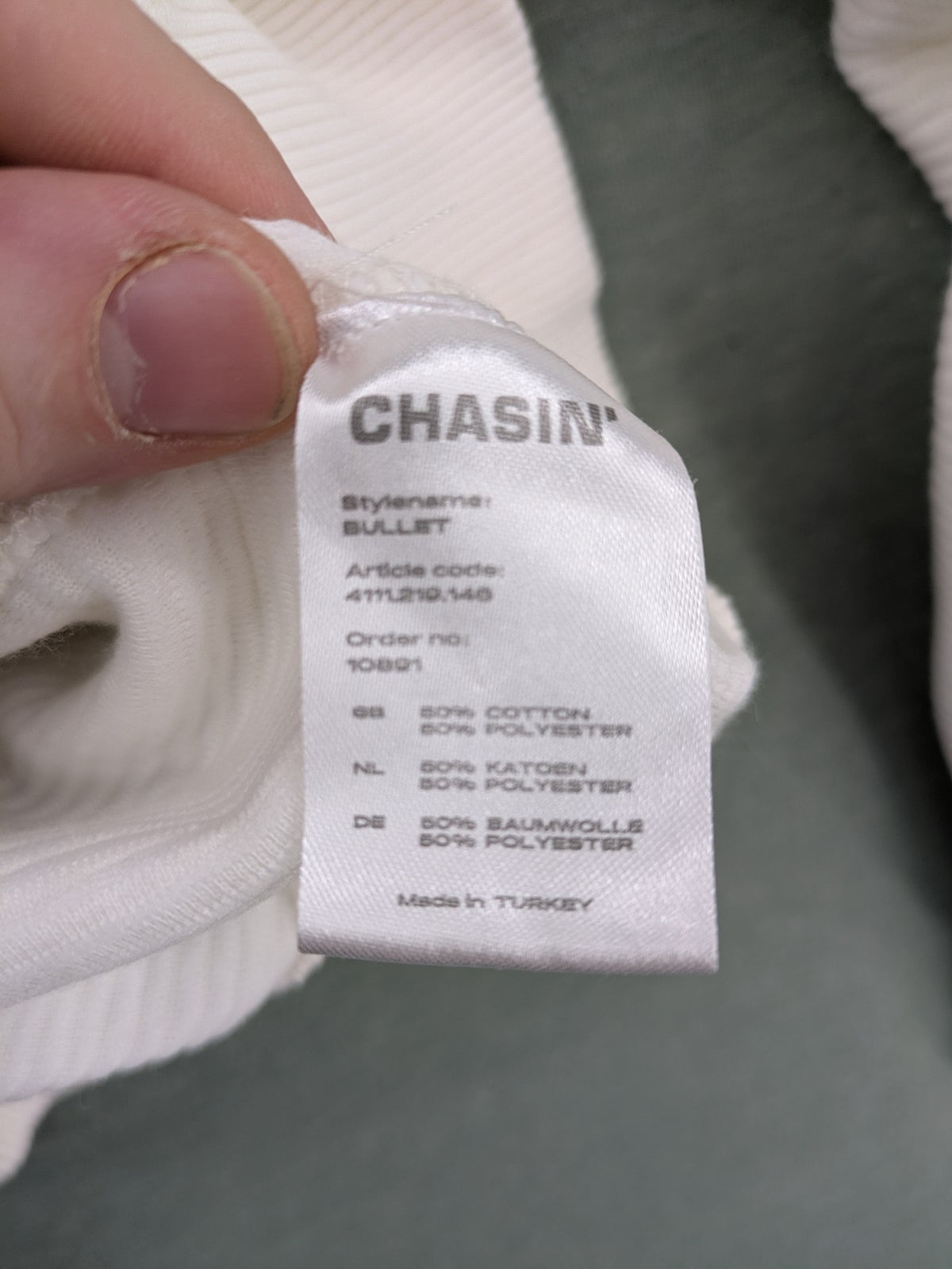 CHASIN' grey and white turtle neck jumper with horizontal ribbed texture and logo patch.