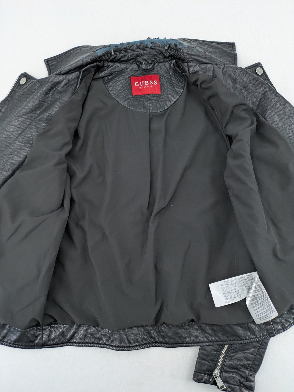 Guess black faux leather biker jacket with asymmetric zipper and multiple zip pockets.