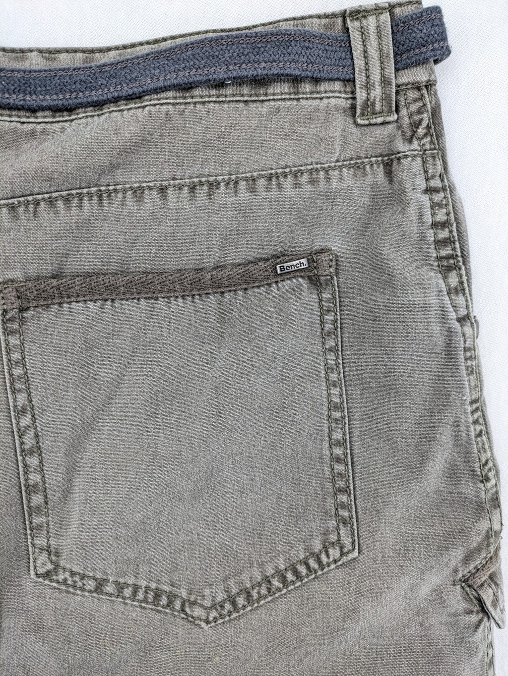 Bench khaki cargo mini skirt with belt, multiple pockets, and durable cotton material.