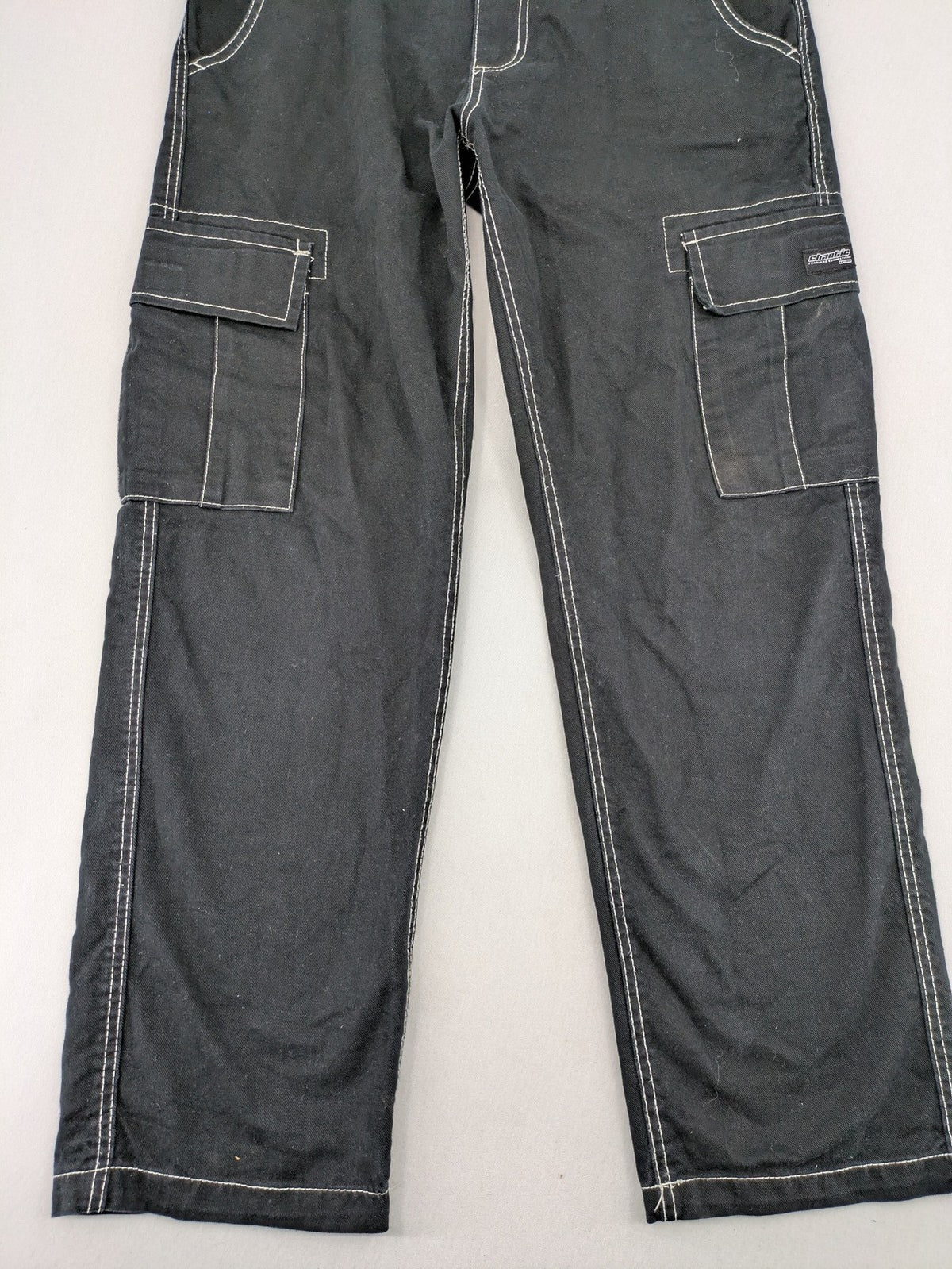 FSBN black baggy cargo pants with white contrast stitching and multiple pockets.