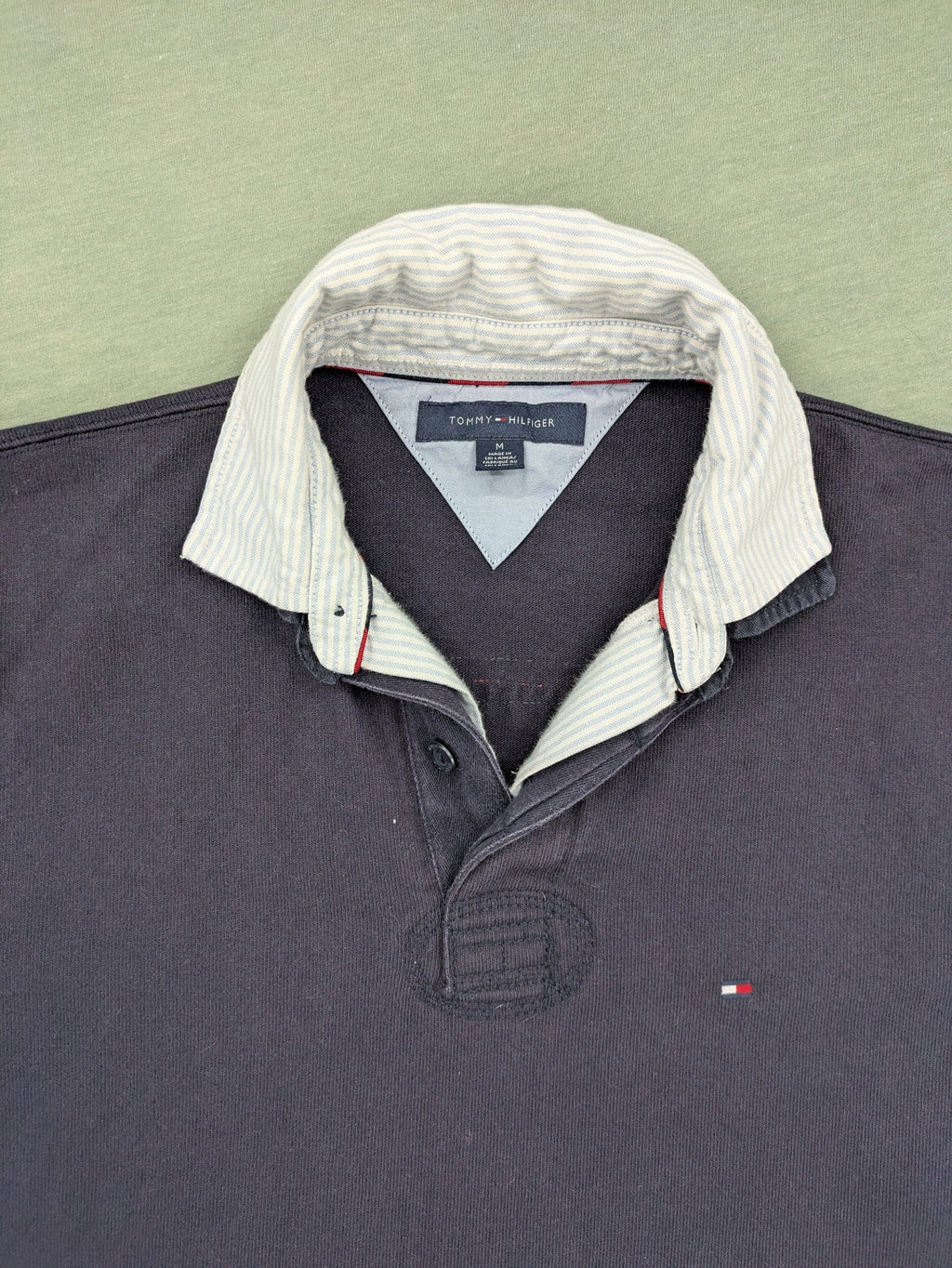 Tommy Hilfiger grey rugby polo shirt with navy striped collar and large H logo.
