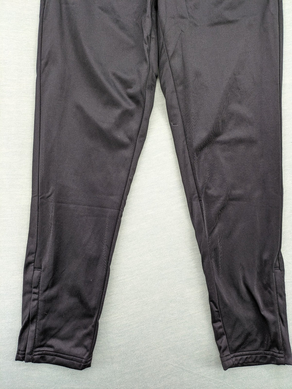 Crivit black weighted training pants with elastic waistband, side pockets, and zippered cuffs.
