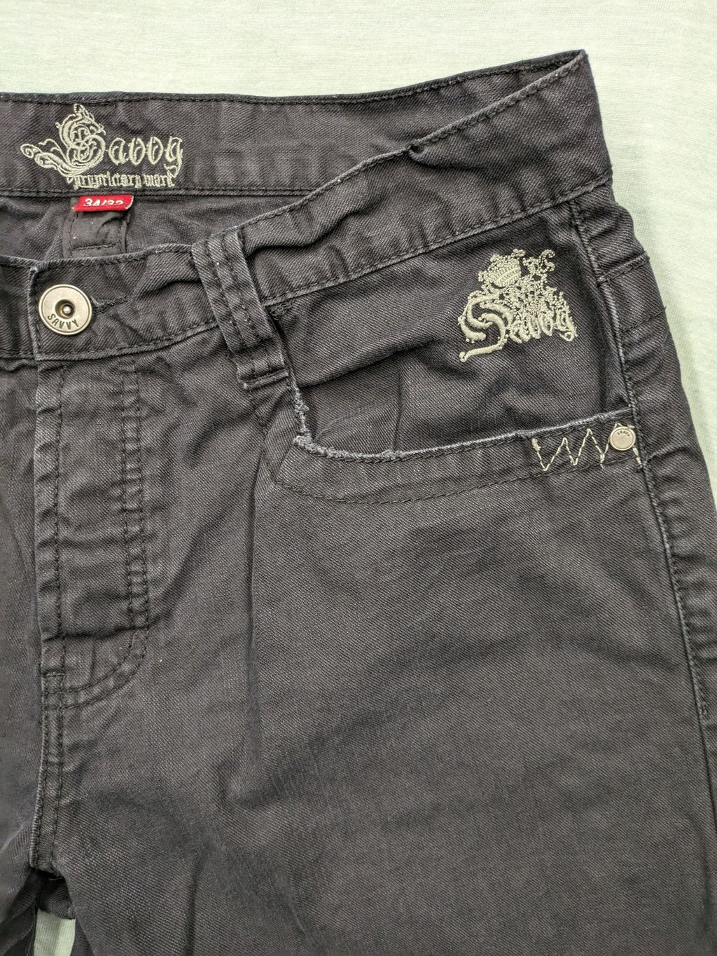 Savvy black pants straight fit with button fly, embroidered details and unique stitching.