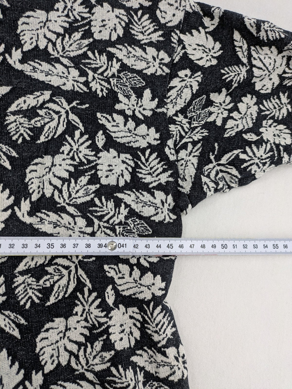 Zara Man black and white t-shirt with allover leaf print and textured knit fabric.