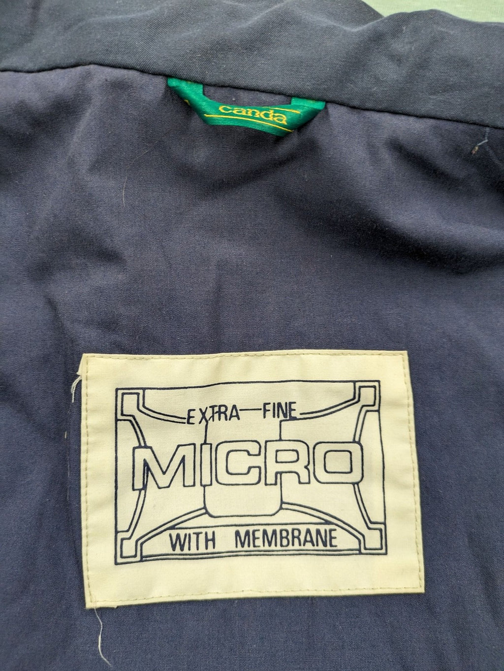 Canda green parka coat with dark lining, multiple pockets, and Micro Membrane technology.