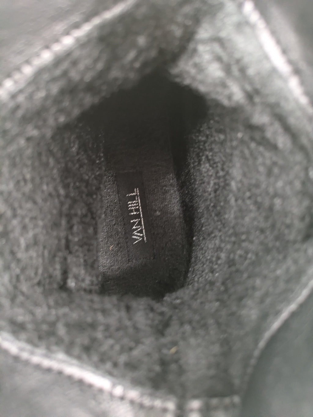 DAF black booties with decorative strap and studded details, made of faux leather.
