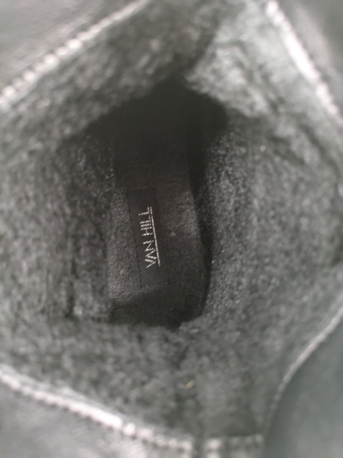DAF black booties with decorative strap and studded details, made of faux leather.