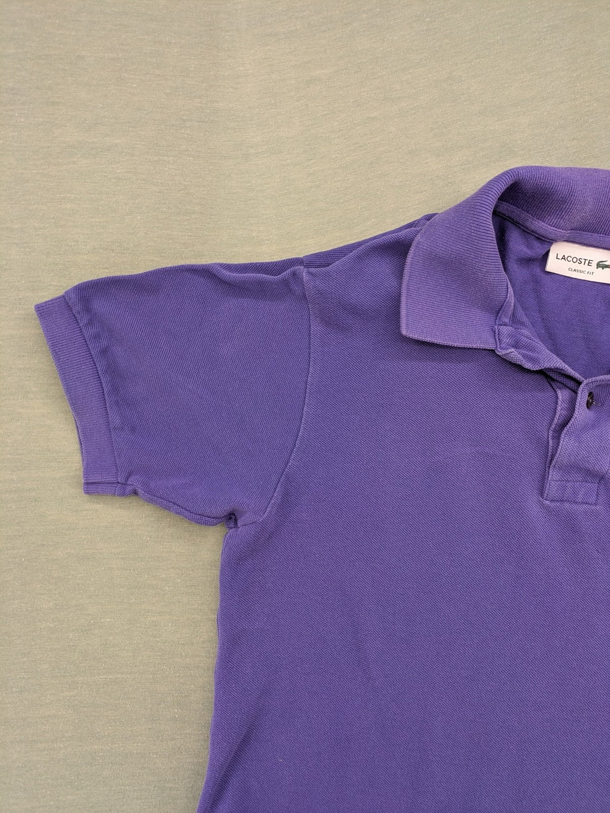 Lacoste purple polo shirt classic fit with embroidered crocodile logo and short sleeves.