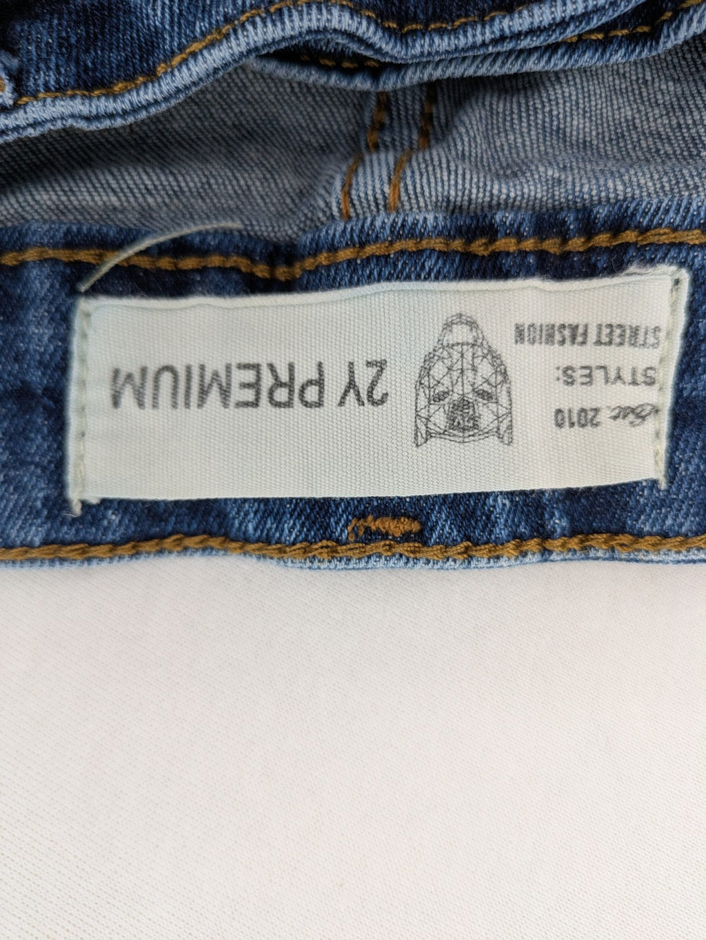 2Y Premium blue skinny jeans with distressed details and classic button fly.