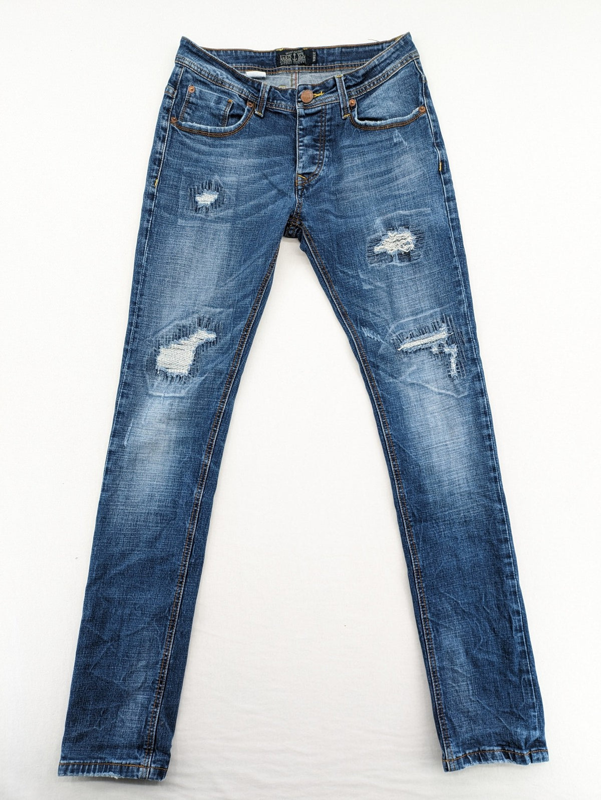 Soda blue straight jeans with distressed rips and button fly, cotton blend material.