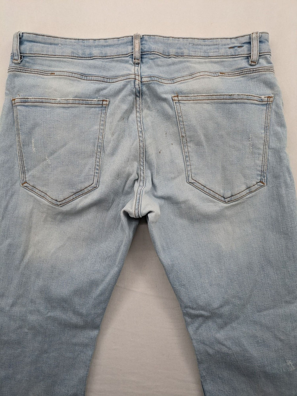 Zara blue straight jeans with distressed knees and classic button fly.