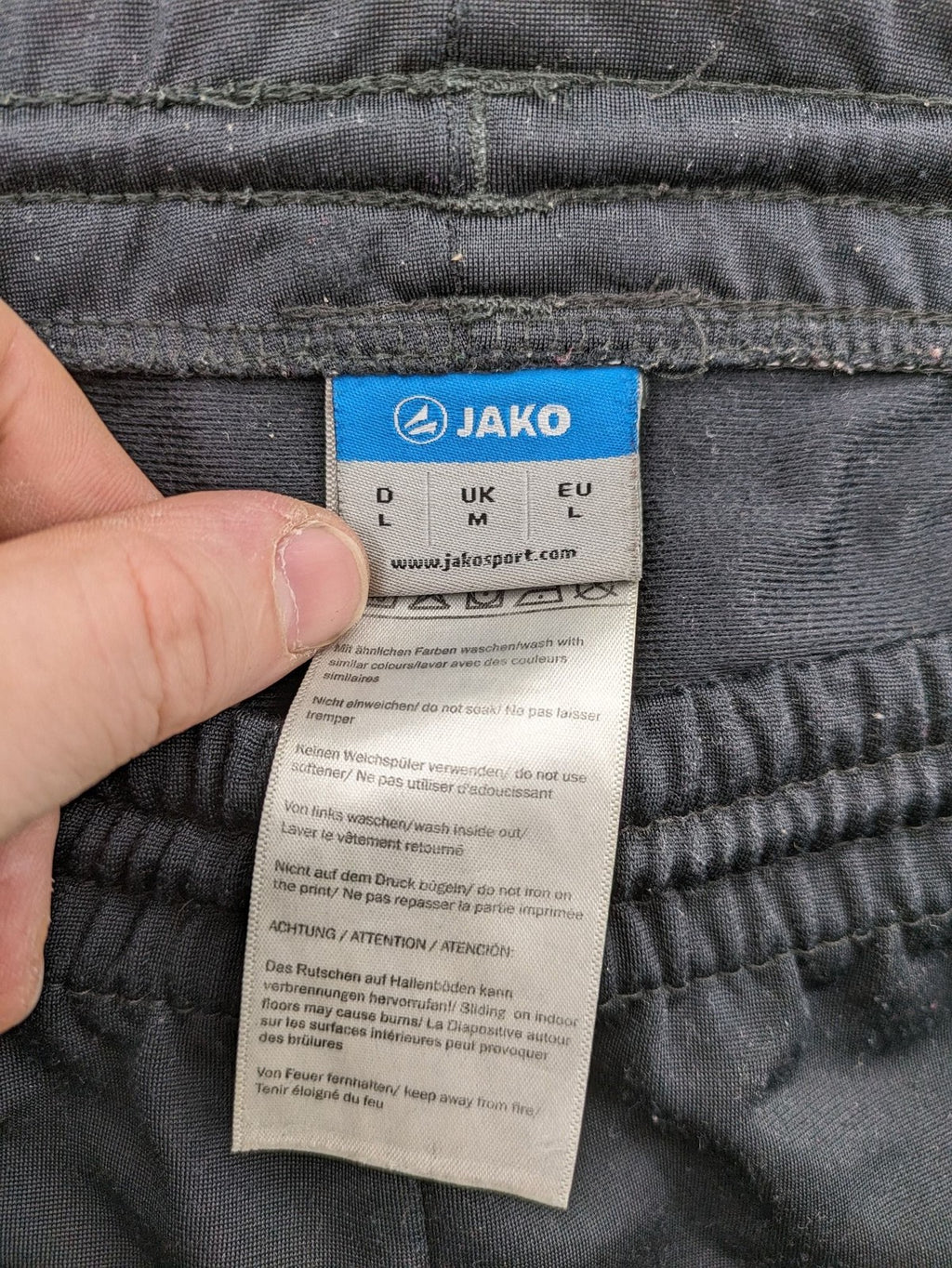 Jako black training pants size L with zippered pockets and elastic waistband.